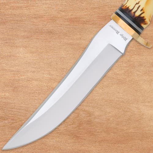 Close-up of stainless steel knife blade on wood