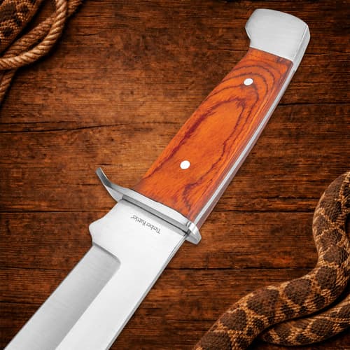 Knife handle with wood texture on a wooden background