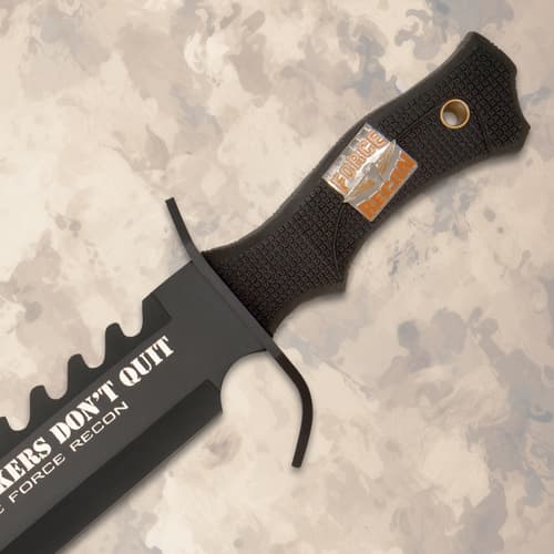 Close-up of knife handle with textured grip and logo