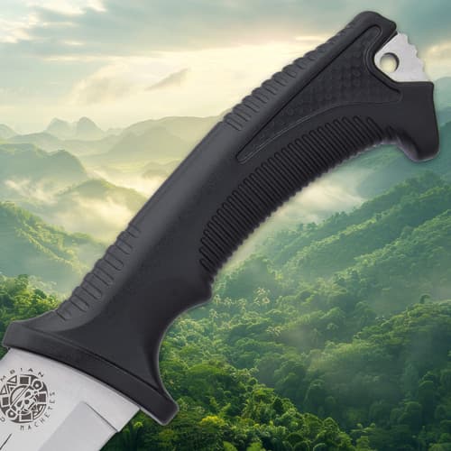 Close-up of machete handle with mountain background