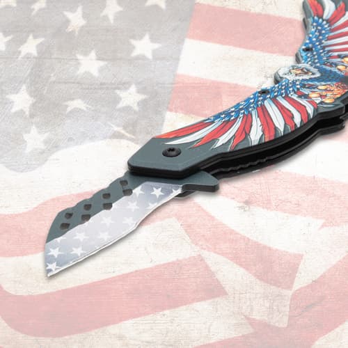 Close-up of knife blade with star pattern on flag backdrop