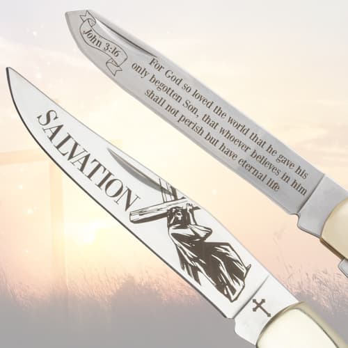 Close-up of pocket knife blades with religious text