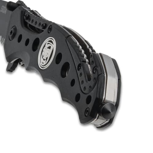 Close-up of knife handle with skull logo and clip