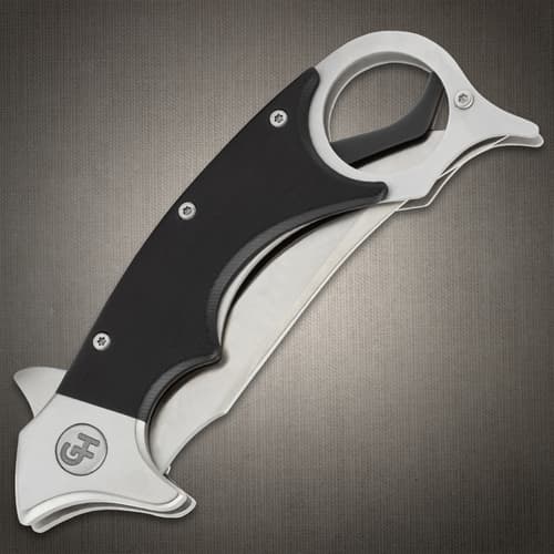 Angled image of the Kerambit opened.