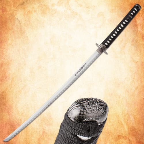 Full view of katana with detailed pommel on textured background