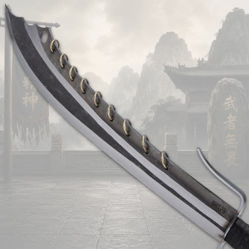 Close-up of sword blade with nine rings and mountain backdrop