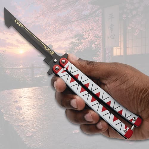 Hand holding butterfly knife with decorative handle