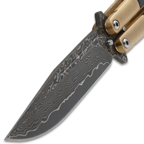 Detailed view of the Damascus blade on a butterfly knife