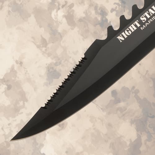 Close-up of serrated knife blade tip on textured background