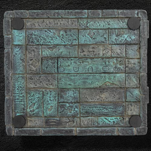 Bottom view of a textured box with Dune branding