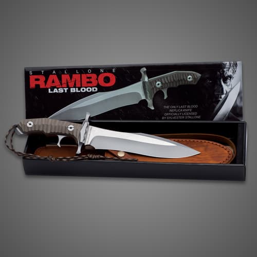 Rambo Last Blood Heartstopper Knife Double-edged stainless steel blade and textured Micarta handle resting on black leather sheath within black box