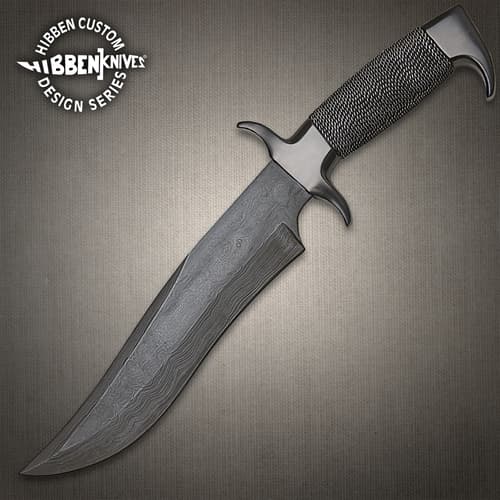 Damascus knife with textured handle on gray background