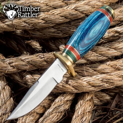 Knife with blue handle on coiled rope background