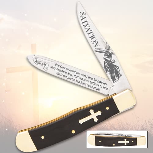 Pocket knife with Christian-themed etched blades and cross handle