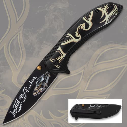 Black pocket knife with car design and text 'Loaded up and Trucking'