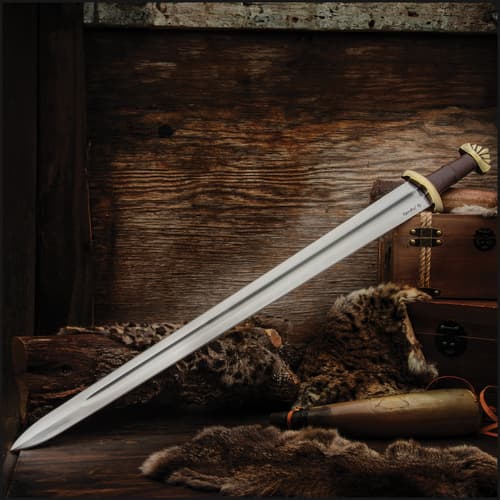 Viking sword displayed on fur and wood with a rustic backdrop