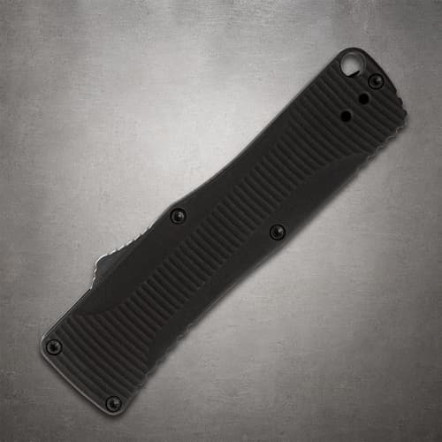 Closed black folding knife with textured grip