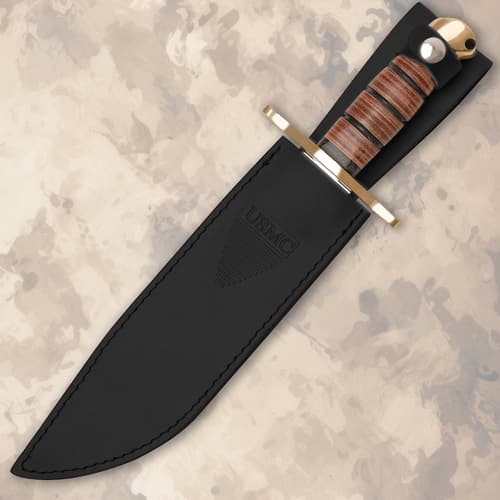 Knife in black sheath on textured background