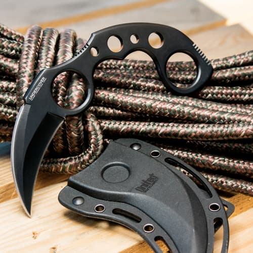 Karambit knife and sheath on coiled rope