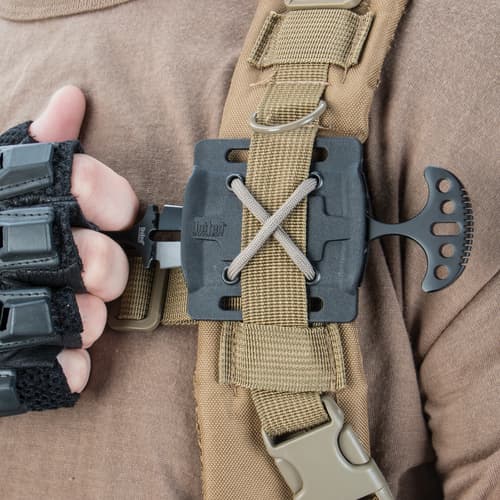 Person holding a dagger attached to a tactical vest