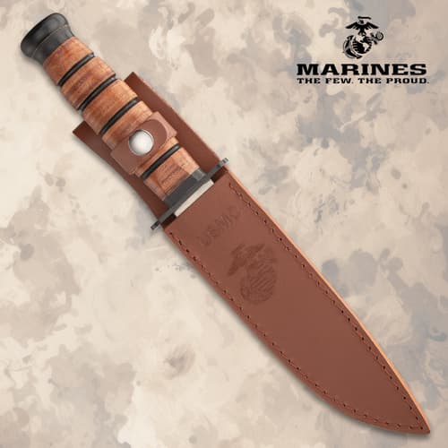 Knife sheathed in brown leather with USMC logo