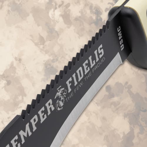 Close-up of kukri knife's serrated blade with USMC logo