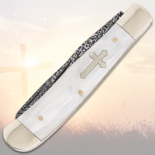 Closed pocket knife with cross inlay on handle