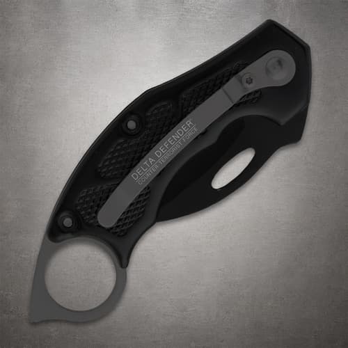 Closed black folding knife with pocket clip and textured grip