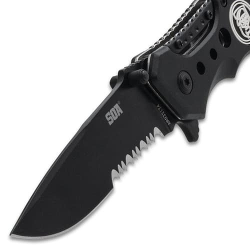 Close-up of black serrated knife blade with logo