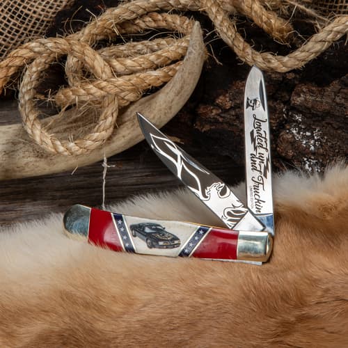 Knife with engraved blades and car design on handle