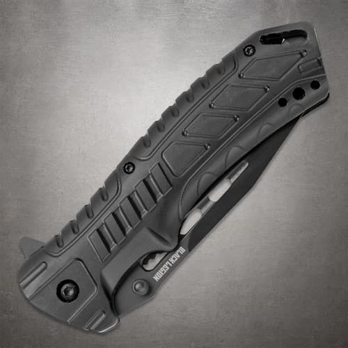 Folded Black Legion pocket knife with a patterned black handle, finger grooves and visible blade cutouts