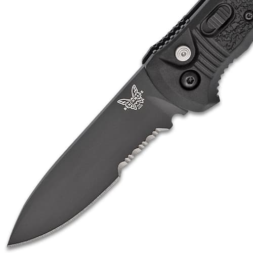 Close-up of a black serrated knife blade with logo