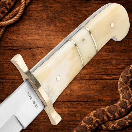 Close-up of knife handle with brass guard