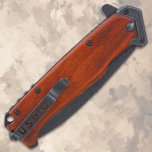 Closed folding knife with USMC on wooden handle