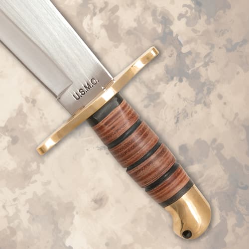 Close-up of knife handle with brass guard