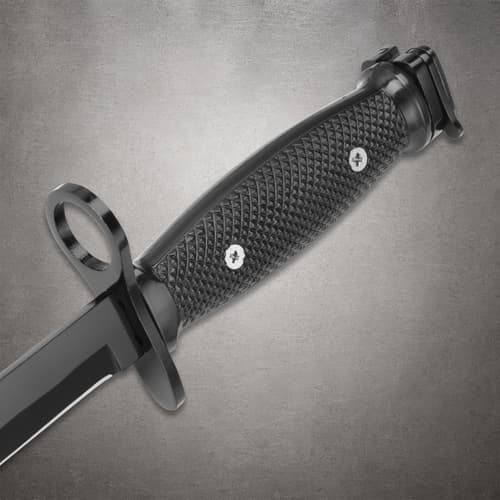 Close-up of black textured knife handle with guard