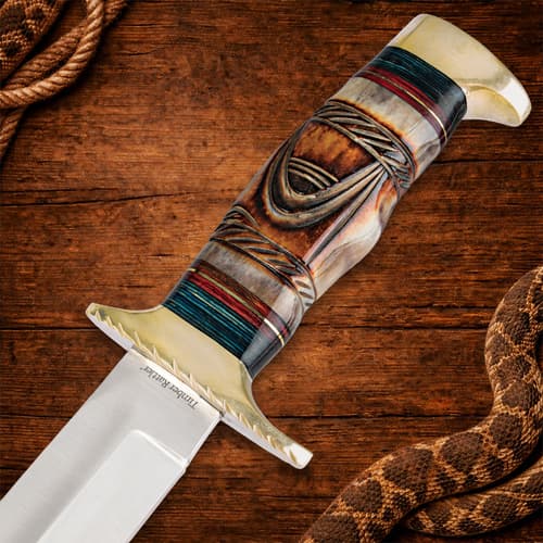 Close-up of Bowie knife handle with intricate design