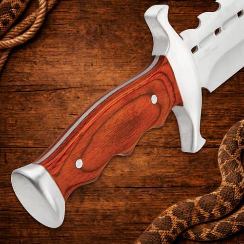 Close-up of wooden handle on a spiked bowie knife