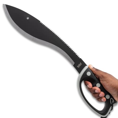 Hand holding a black kukri machete with serrated back