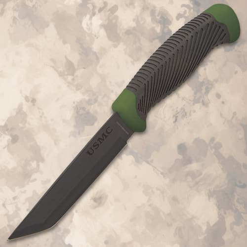 Black knife with textured handle and green accents