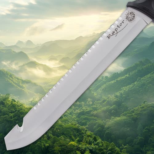 Close-up of machete blade over lush green mountains