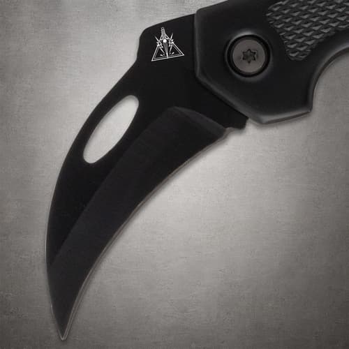 Close-up of black knife blade with logo