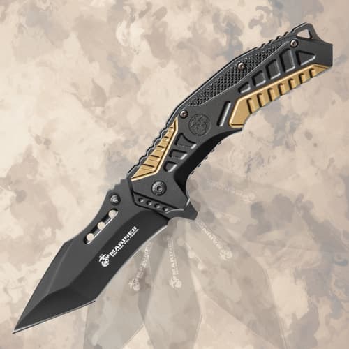 Open black and gold tactical knife with Marines logo