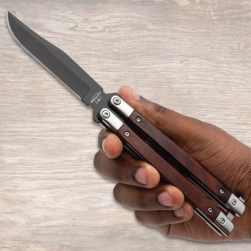 Hand holding a butterfly knife with wooden handles