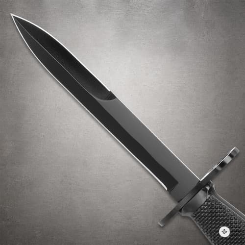 Black knife blade with textured handle on gray background