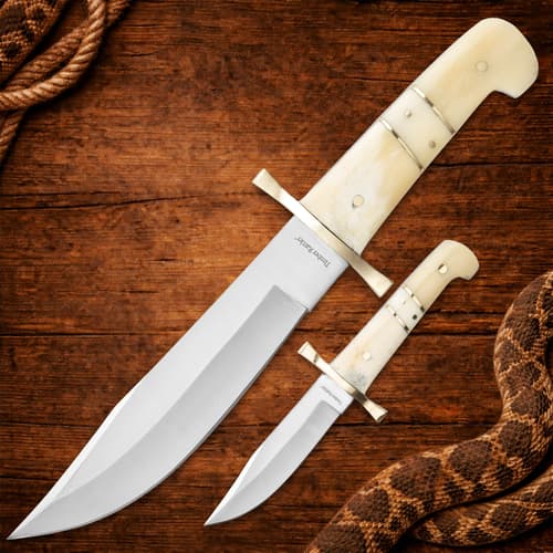 Two knives with bone handles on wood surface