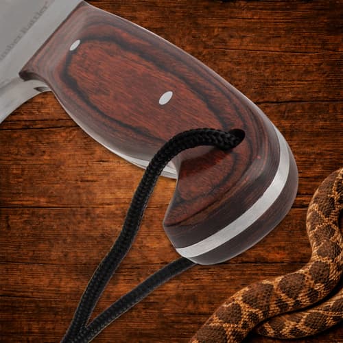 Close-up of knife's wooden handle with lanyard