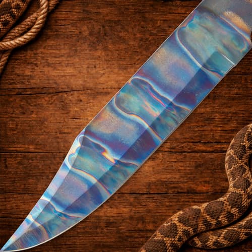 Close-up of colorful knife blade on wooden background