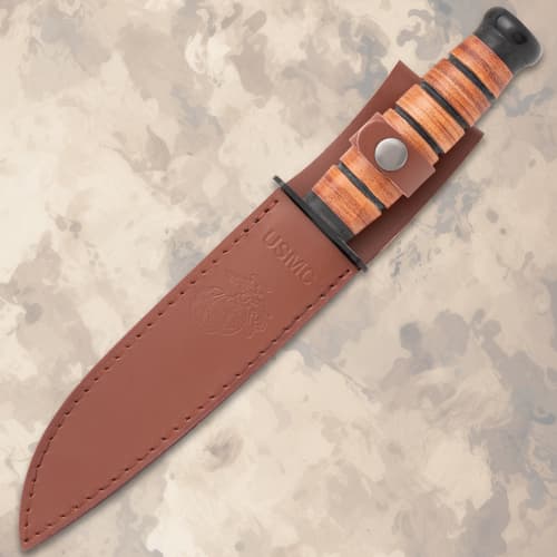 Knife in a brown leather sheath with USMC embossing