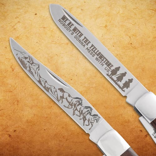 Two engraved blades of a pocket knife with western motifs